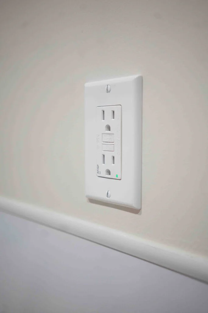 Close-up of a newly installed white GFCI electrical outlet