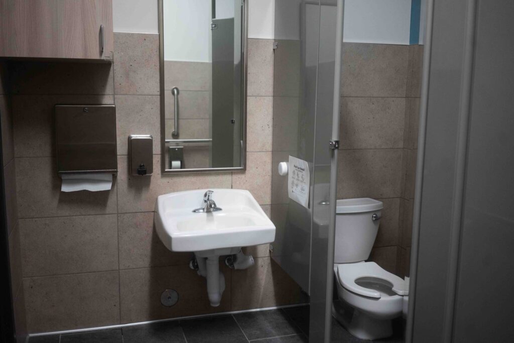 Angled view of a hallway wall with two small transom windows near the ceiling