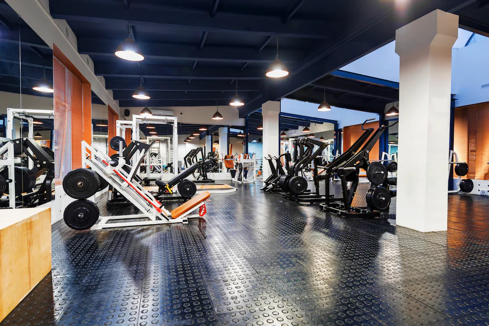 Interior of a modern gym with rows of weight training machines